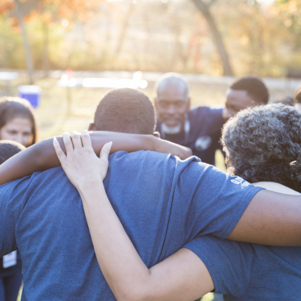 People with arms around each other